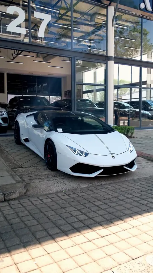A white Lamborghini Huracán outside the Aksons showroom at 27 Meridian Drive