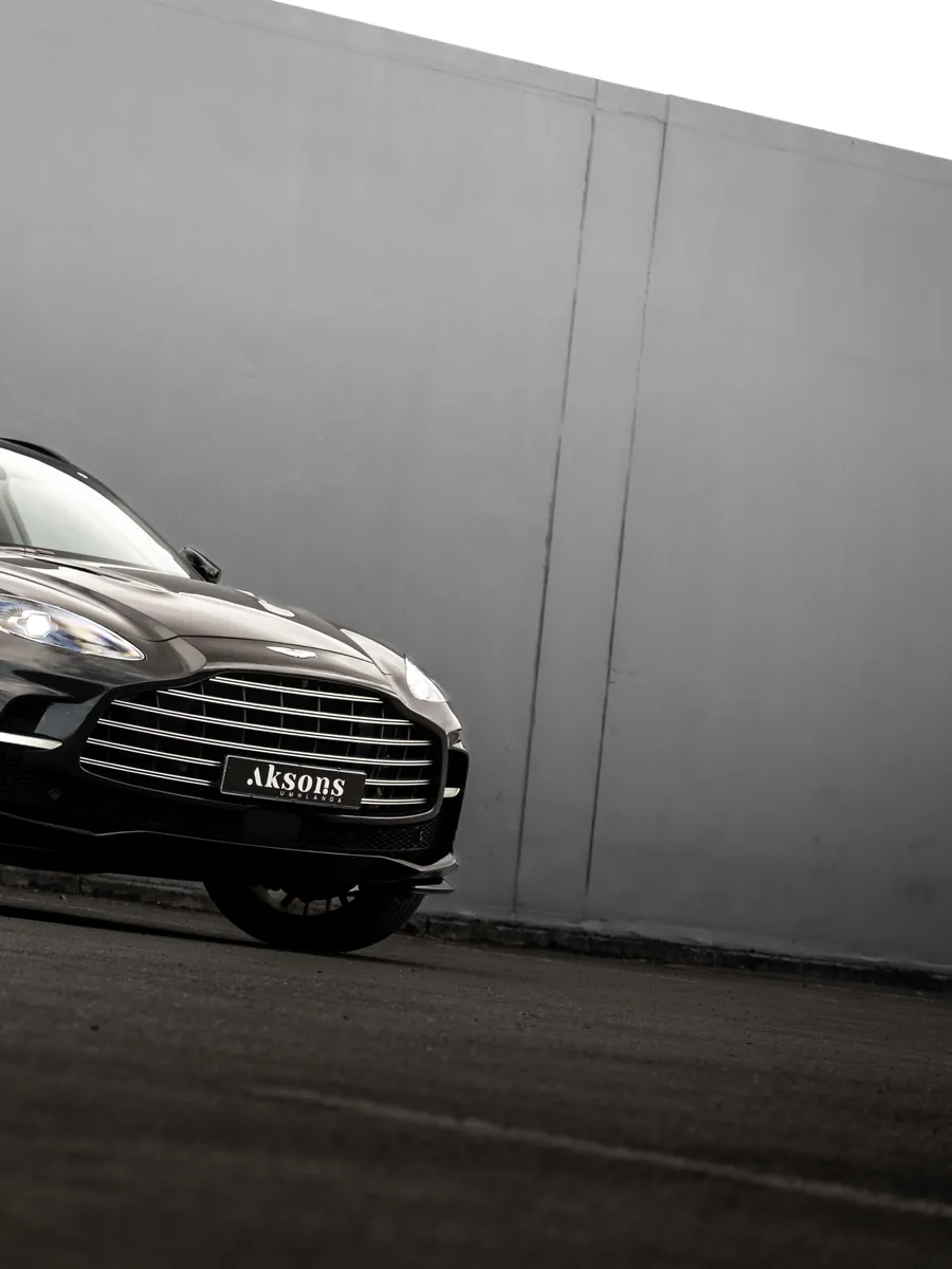 An Aston Martin DBX 707 photographed by Aksons against a concrete wall